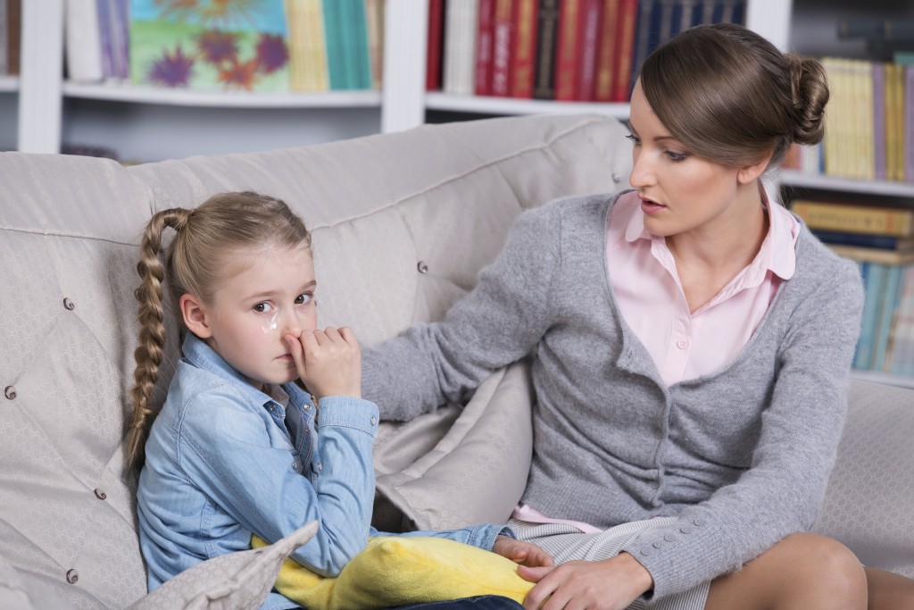 Child psychologist with a little girl, a child is crying