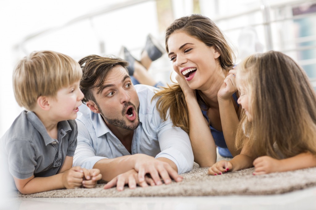 Happy young family lying down and enjoying in their talk.